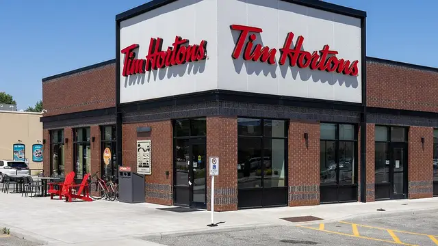 A Tim Hortons restaurant with red patio chairs in Kingsville, Ontario
